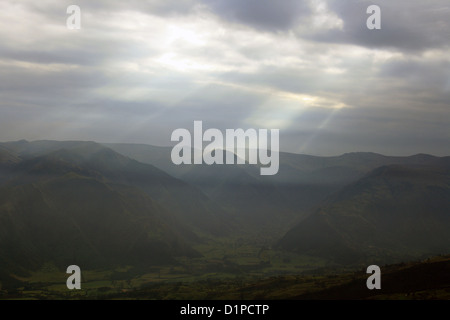 Rays of sunshine coming through the clouds and illuminating mountain peaks in the Andes Mountains in northern Ecuador Stock Photo