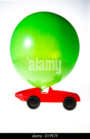 Toy car, powered by the air of a blown up balloon. The effluent air drives the car forward. Symbol image, alternative power. Stock Photo