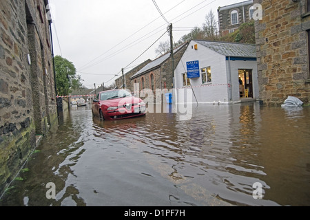 Helston Flood, car in flooded street outside butchers shop in the St Johns area of Helston Stock Photo