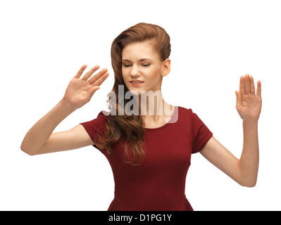 girl in red dress working with something imaginary Stock Photo
