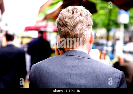 business man in grey suit on mobile (cell) phone Stock Photo