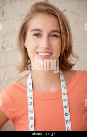 Caucasian woman with measuring tape around her neck Stock Photo
