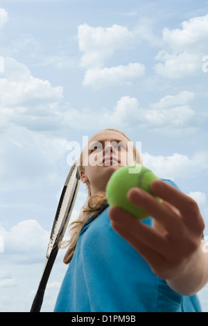 Caucasian teenage boy playing tennis Stock Photo