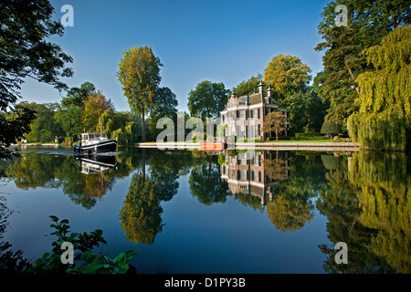 The Netherlands, Nieuwersluis, Pleasure boat on the river Vecht. Rural estate called Rupelmonde. Stock Photo
