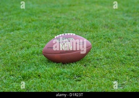 American Football Ball on Grass Stock Photo