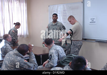 Spc. John Munnelly, 23, who is originally from Elk River, Minn., shows Soldiers of 210th Fires Bde. how to properly wrap an injury during the Combat Lifesaver Certification Training or CLS at the Camp Hovey Education Center on Jan. 2 in South Korea. (Photo by 210th Fires Bde., Public Affairs NCO Staff Sgt. Carlos R. Davis). Stock Photo