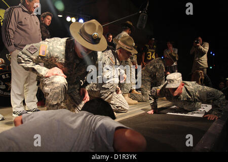 All-American high school football players and bandmembers take on Soldiers in an East-West pushup challenge Jan. 2, just days before the U.S. Army All-American Bowl. U.S. Army drill sergeants motivate contestants to push. (U.S. Army photo by Staff Sgt. Keith Anderson, Army North PAO) Stock Photo