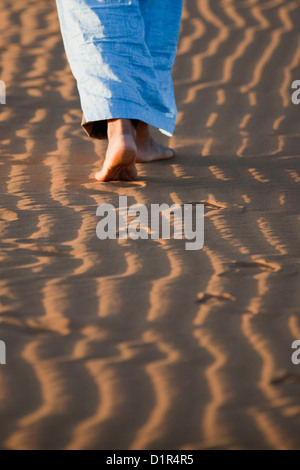Morocco, M'Hamid, Erg Chigaga sand dunes. Sahara desert. Detail ripple-marks. Local Berber man walking Stock Photo