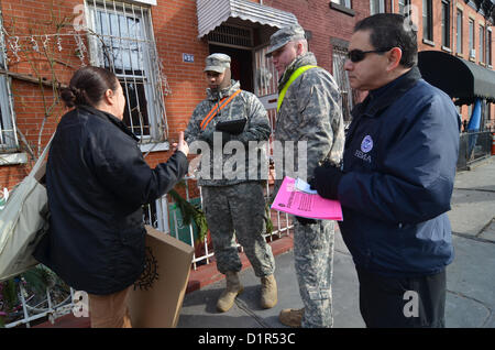 More than 30 members of the New York National Guard walked door-to-door in New York to assist the survivors of Hurricane Sandy. National Guardsmen Spc. Jones of the HSC642-ASB unit, and Spc. Pimiental, Bravo Company 642 AB, took part in Operation 'Task Force Sandy' by walking along Pioneer Street in the Red Hook area of Brooklyn. They told us there were 30 members of their unit working in the area doing “wellness checks” to see if citizens had electricity and heat. If the resident had electricity but no heat, they would provide a portable heater for the resident.2 Jan 2013 (Walt Jennings/FEMA) Stock Photo