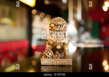 small chinese lion statue in a china restaurant Stock Photo