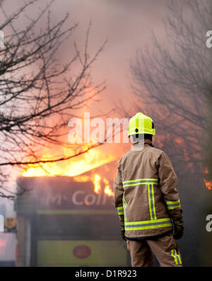 Laindon, Basildon, Essex, 3rd January 2013. Four shops in a parade known as the Triangle Shops were destroyed in a severe fire that was believed to have been caused by an electrical fault in a vent.  The fish and chip shop, the Chinese take away, the hairdressers and the McColl convenience store were totally destroyed. Four pumps from the Essex Fire Service tackled the blaze. It is believed that no-one was injured. Stock Photo