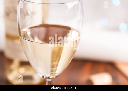 glass and bottle white wine on blink light background Stock Photo