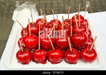 Beautiful tasty red candy apples on a table. Stock Photo