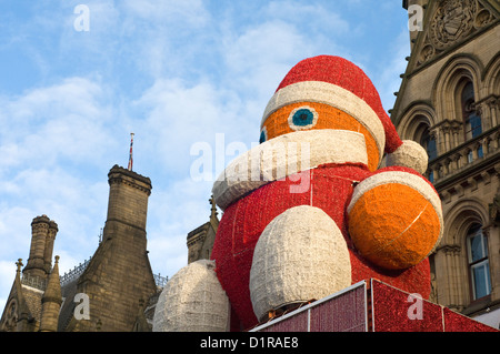 Giant Santa figure outside Manchester town hall in Albert Square, England, UK Stock Photo