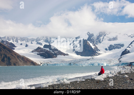 Woman enjoying the view of the Weddell glacier in Royal Bay, South Georgia Island, Antarctica Stock Photo