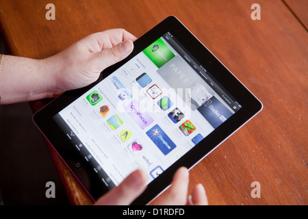 A woman looks at the App Store on an iPad 4 Stock Photo