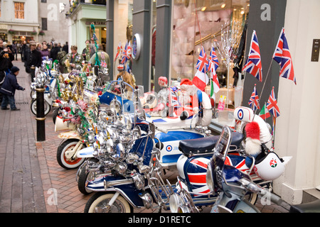 Scooters lambretta displaying union jacks on display and  parked in Carnaby street, London, England, Great Britain Stock Photo