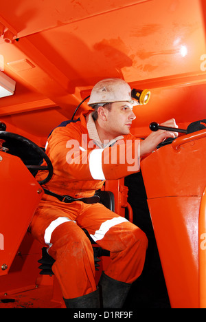 Miner in the drilling machine cockpit stock photo Stock Photo