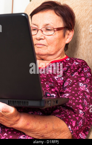 Close up of senior woman using laptop. Stock Photo