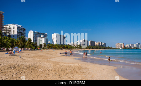 San Juan Puerto Rico Isla Verde beach with sunbathers, blue sky and ...