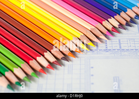 Color pencils in a neat row on blueprint Stock Photo