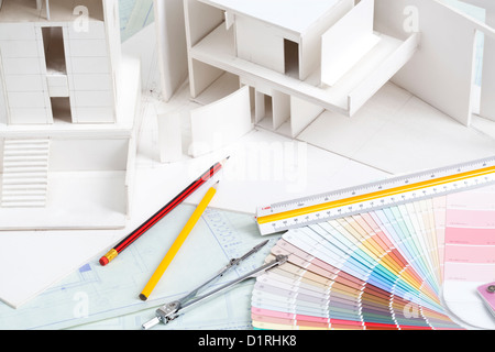 Architectural model with other office stationery on blueprints Stock Photo