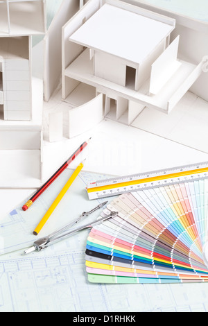Architectural model with other office stationery on blueprints Stock Photo