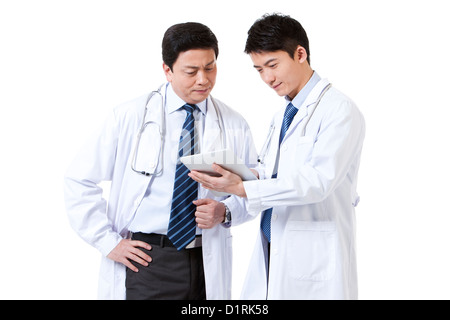 Two professional male doctors using digital tablet Stock Photo
