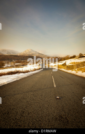 Afternoon sunshine over the A5084 road to Torver in the English Lake District National Park Stock Photo