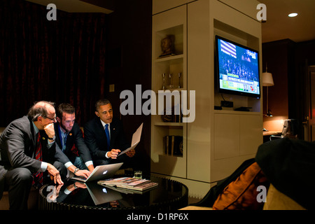 US President Barack Obama works on his acceptance speech with Jon Favreau, Director of Speechwriting, and campaign advisor David Axelrod while waiting for the concession call from Gov. Mitt Romney November 6, 2012 in Chicago, IL. Stock Photo