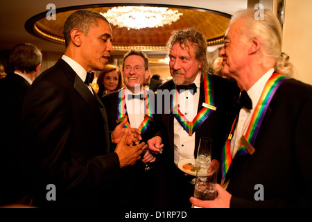 US President Barack Obama speaks with the surviving members of Led Zeppelin (left to right0 John Paul Jones, Robert Plant and Jimmy Page during intermission at the Kennedy Center Honors December 2, 2012 in Washington, DC Stock Photo