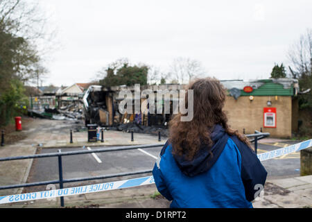 Triangle Shops, Laindon, Basildon, Essex. The day after a fire ripped through four businesses razing them to the ground. Local resident and customer of the Mc Coll's store surveys the aftermath of the fire.  Credit:  Allsorts Stock Photo / Alamy Live News Stock Photo