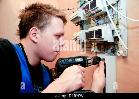 Young electrician installing an electricity system Stock Photo