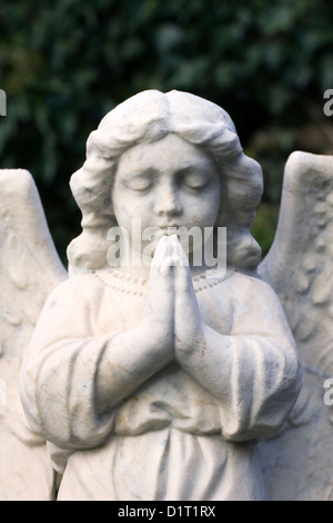 Angel sculpture on a grave in an English churchyard. Stock Photo