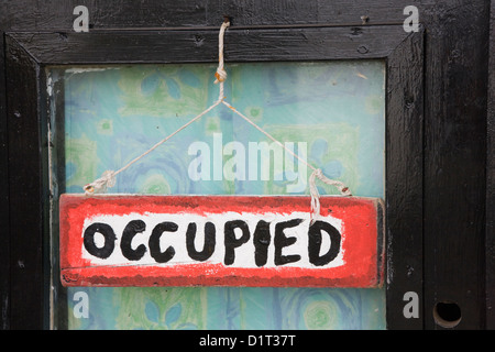 A sign indicating that the composting toilet is occupied Stock Photo