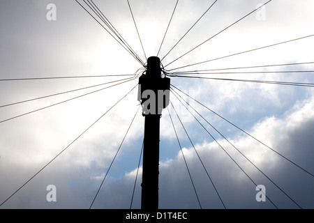 telegraph pole with dark clouds & blue sky Stock Photo