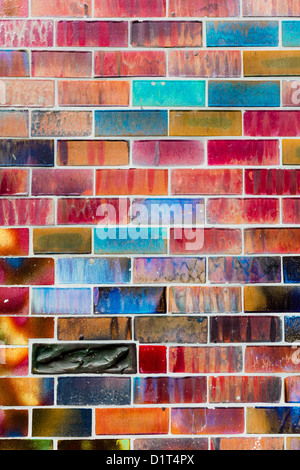 Glazed bricks in shimmering, iridescent colours and a dark accent brick form a wall surface in Berlin, Germany. Taken on 29 April 2012. Stock Photo