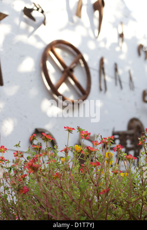 Old, rusting, farm tools hanging on a wall Stock Photo