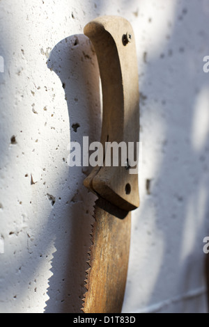 Old, rusting, farm tools hanging on a wall Stock Photo