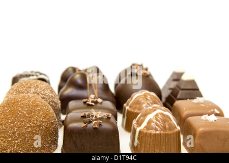 Rows of Chocolate Assortment with Truffles Dark Milk Salt Nut Isolated on White Background Stock Photo