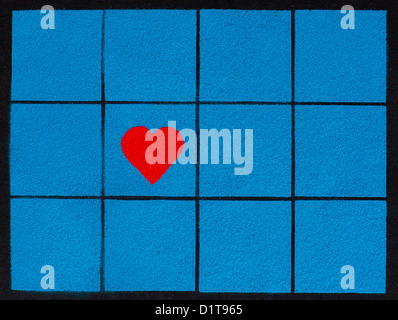 Red heart shape on blue coloured powder square pattern Stock Photo