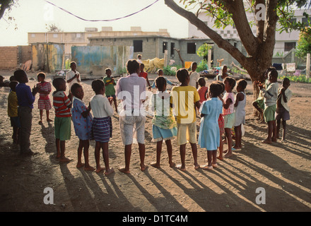 Children singing in a circle outside a primary school in a village in Haiti Stock Photo