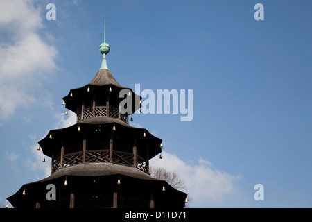 The Chinese Tower in the English Garden in Munich Germany is shown against a bright blue Bavarian sky. Stock Photo
