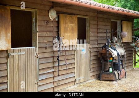 An outdoor view of a wooden horse stable with 3 doors in Chamont, France. Stock Photo