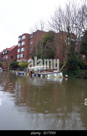 Traditional Broads cruiser sunk at her moorings in Thorpe on the outskirts of Norwich on the River Yare, Broads National Park Stock Photo