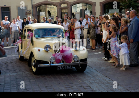 Colmar, France, a newly married couple rides with the wedding car in the old town Stock Photo