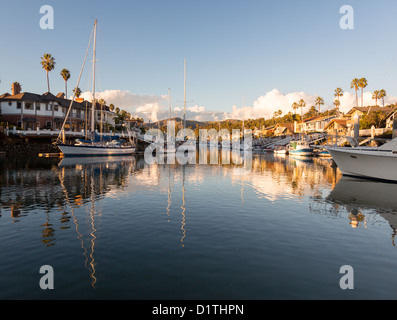 Sunset over residential development by water in Ventura, California USA with luxury modern homes and yachts boats Stock Photo