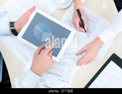 Business people developing a business project and analyzing market data information on a modern digital tablet computer. Stock Photo