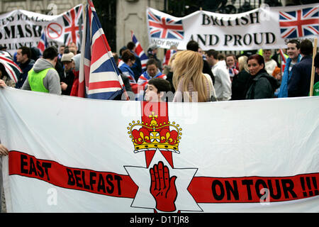 Belfast, UK. 5th Jan, 2013. A youth behind the Ulster Flag with 'East Belfast on Tour' written across it , was at the flag protest which took place in Belfast after the City Council voted on the 3rd of December 2012 to restrict the flying the Union Jack flag from City hall to 17 days per year, where previously it flew evey day of the year. Stock Photo