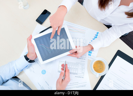 Businessman discussing with financial analyst business development strategy project and using modern digital tablet with chart. Stock Photo